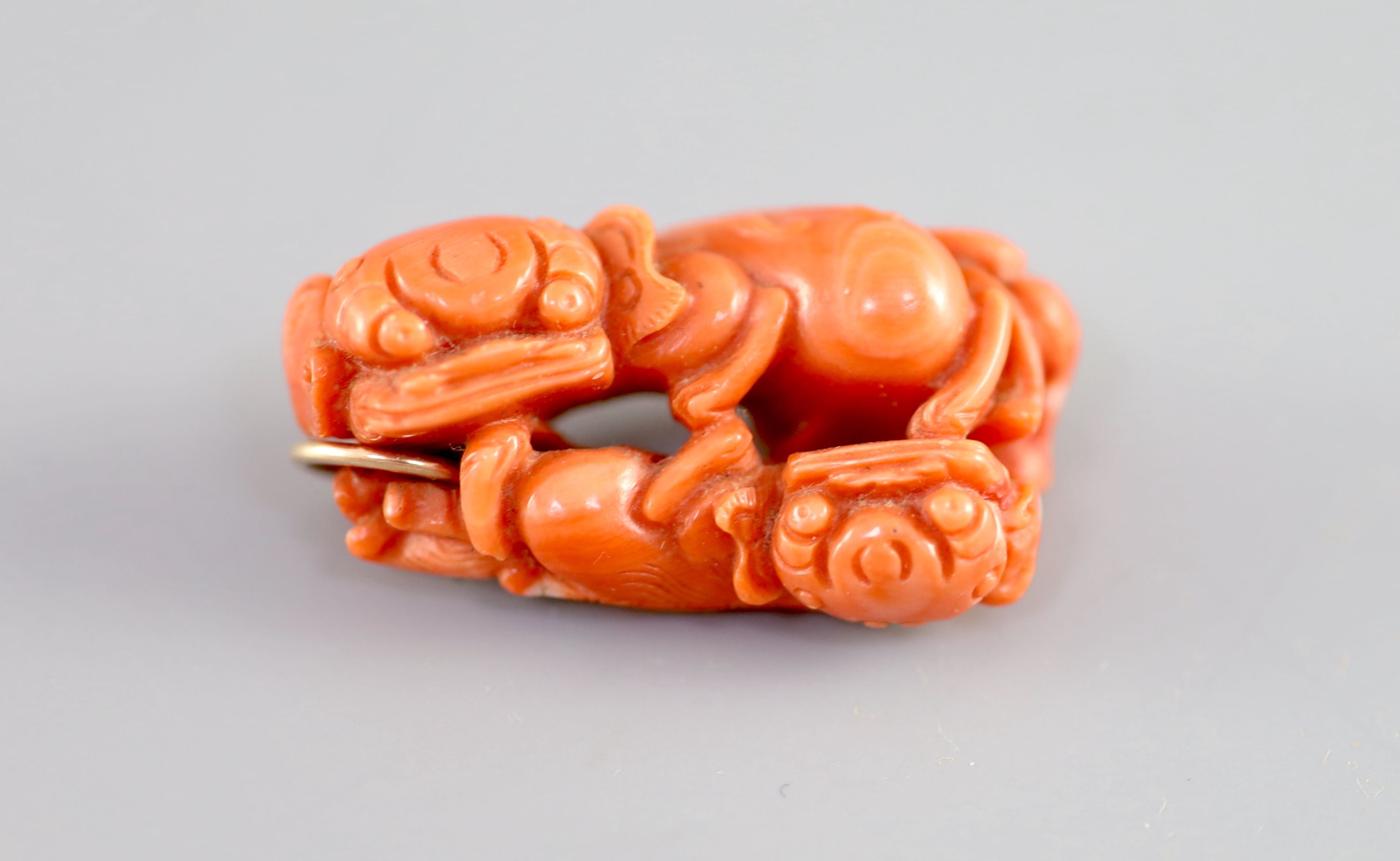 A Chinese coral ‘lion-dog’ pendant, 19 century, 3.8cm